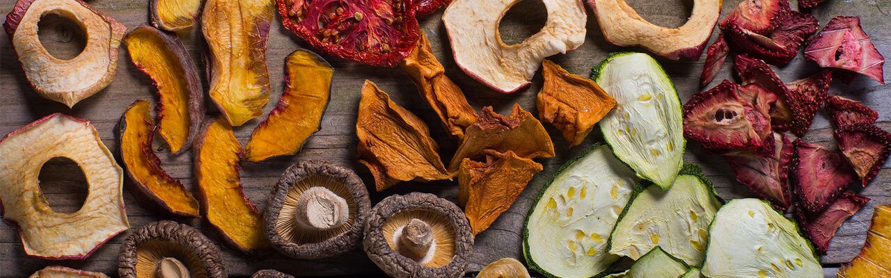 An assortment of organic dried fruits and vegetables prepared for cooking.