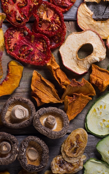 An assortment of organic dried fruits and vegetables prepared for cooking.